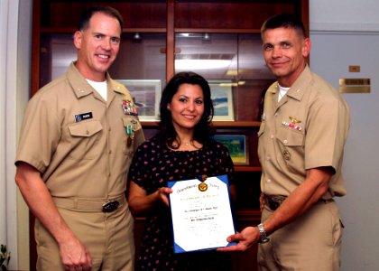 US Navy 050516-N-0879R-003 Pacific Fleet Deputy and Chief of Staff for Operations, Plans, and Policy, Rear Adm. Douglas L. McClain, presents Deputy Commander, Submarine Squadron One, Capt. Mark Olson and his wife Linda, the Nav