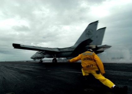 US Navy 050413-N-8704K-001 A catapult shooter signals the launch of an F-14D Tomcat
