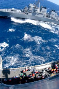 US Navy 050424-N-8154G-074 Sailors stationed aboard guided missile destroyer USS Laboon (DDG 58) receives tending lines from crew members aboard amphibious assault ship USS Bataan (LHD 5)