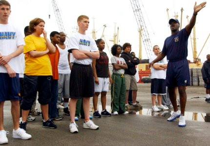 US Navy 050423-N-4729H-029 Chief Hospital Corpsman Ken Montgomery, assigned to the Military Sealift Command (MSC) hospital ship USNS Comfort (T-AH 20), explains the 1.5 mile running course to Delayed Entry Personnel (DEP)