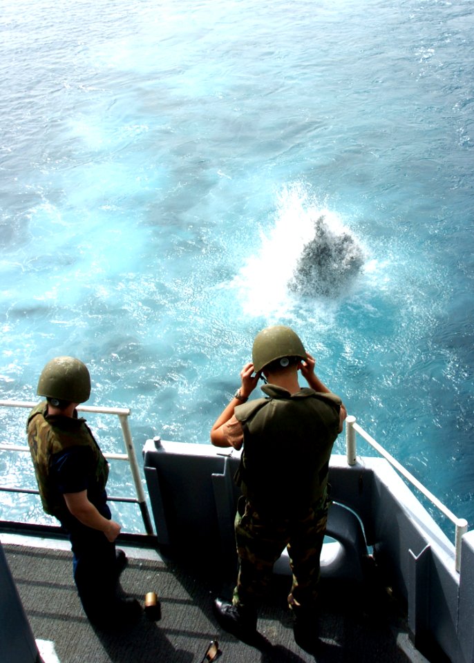 US Navy 050519-N-9446C-009 Chief Master-at-Arms Timothy Schele, right, assigned to the Security Force aboard USS Carl Vinson (CVN 70), instructs Sailors on the safe use of flank grenades during live grenade training on the fant