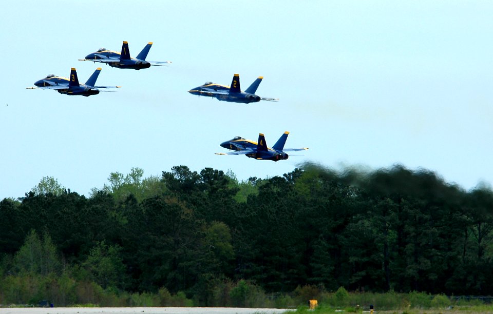 US Navy 050416-N-0295M-089 Four F-A-18A Hornets, assigned to the U.S. Navy flight demonstration team, the Blue Angels, takeoff in a tight formation during the 2005 Coastal Carolina Air Show in Wilmington, N.C