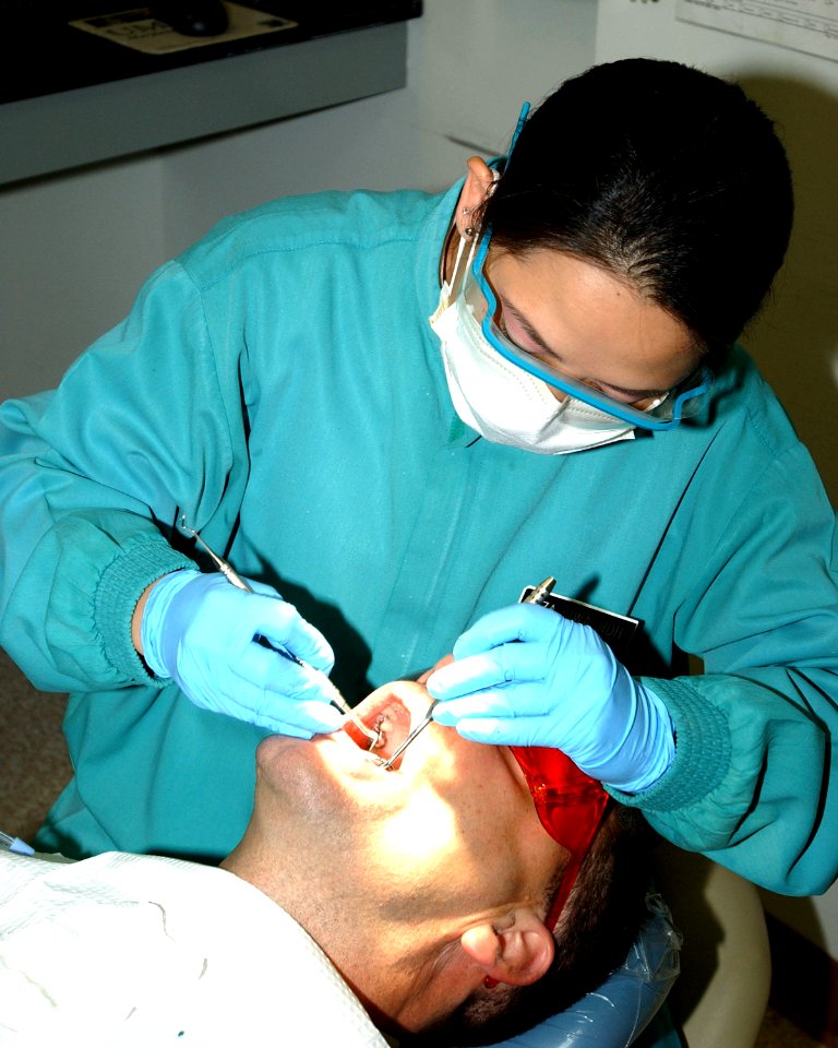 US Navy 050427-N-9693B-004 Dental Hygienist Liza Siwa conducts a routine cleaning