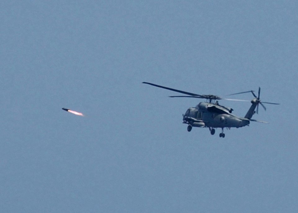 US Navy 050427-N-7512V-006 An HH-60H Seahawk helicopterfires an AGM-114B Hellfire missile at a weapons training site off the coast of Okinawa