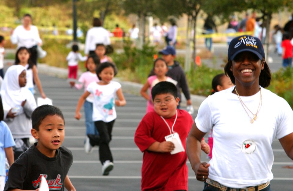 US Navy 050429-N-8158F-088 Seaman Angela Carswell from Macon, Ga., runs with students competing in the 18th annual Jog-a-Thon in support of the Zamorano elementary Parent Teacher Foundation (PTF) fundraiser
