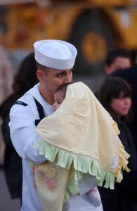 US Navy 050507-N-8158F-105 A Sailor assigned to the nuclear powered aircraft carrier USS Nimitz (CVN 68) spends a moment with his child before boarding the ship