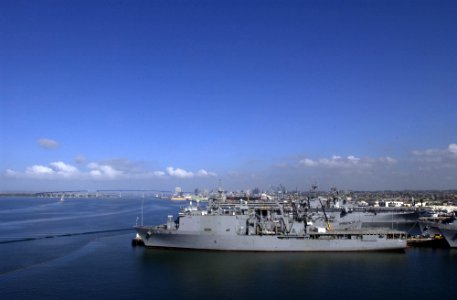 US Navy 050330-N-9866B-003 The amphibious dock landing ship USS Comstock (LSD 45), foreground, and other U.S. Navy vessels sit in port on board Naval Station San Diego, Calif photo