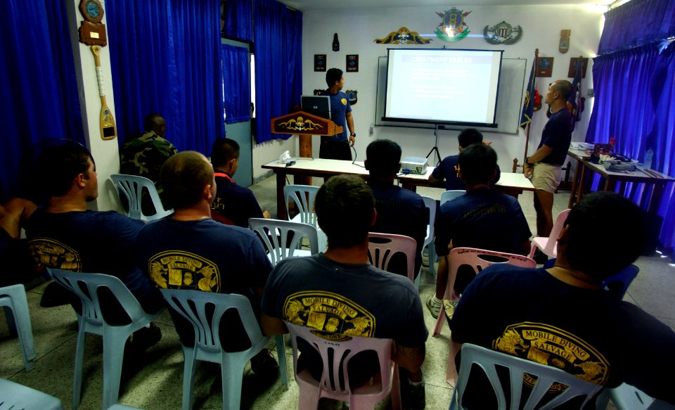 US Navy 050507-F-6335P-003 U.S. Navy Petty Officer 1st Class Val Lapena, assigned to Mobile Diving Salvage Unit One (MDS-1) gives a lesson on diving decompression to Royal Thai Navy divers