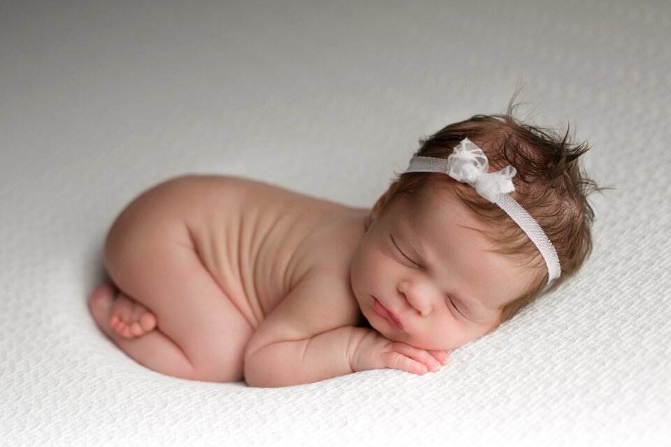Baby girl sleeping curled up