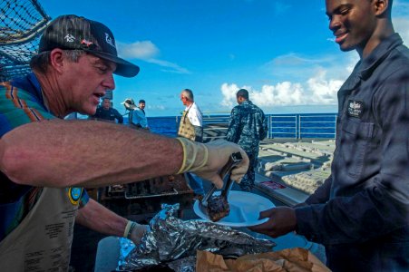 USS Antietam Sailors receive steak dinner 141106-N-ZZ786-208