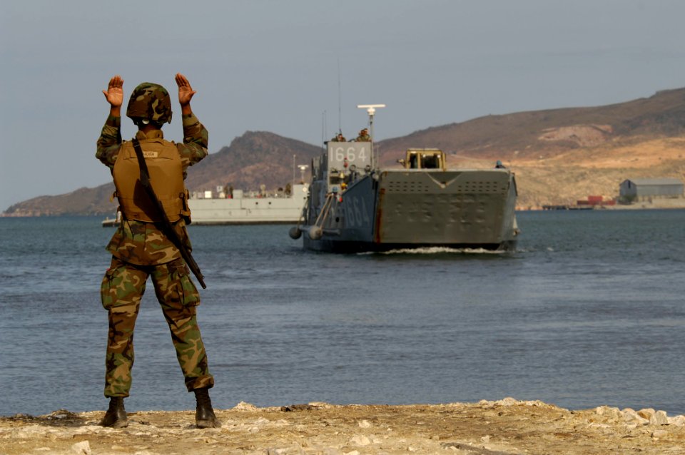 US Navy 050509-N-3642E-008 Seaman Emanuel Walker from Beach Master Unit Two (BMU-2) directs an inbound Landing Craft Utility (LCU)