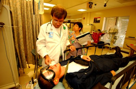 US Navy 050526-F-5586B-100 Medical Director Emergency Department, John Hybart, performs a medical evaluation on a simulated victim during exercise Lifesaver 2005 at Pensacola Naval Air Station