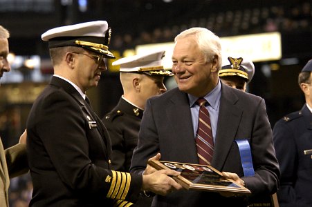 US Navy 050405-N-6477M-111 Capt. Robert D. Schlesinger represents the Navy Region Northwest as he receives a plaque of appreciation from President and Chief Operating Officer of the Seattle Mariners Baseball Team photo