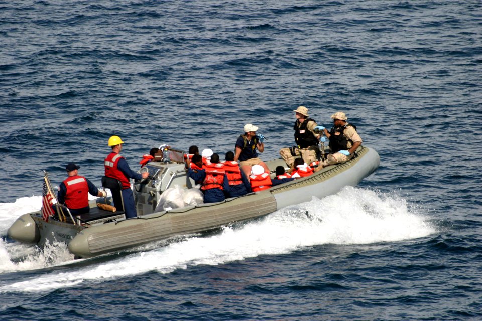 US Navy 050429-N-0000X-001 A rigid hull inflatable boat carry survivors rescued from the Gulf of Aden to the coastal patrol ship USS Firebolt (PC 10) after their small vessel capsized 25 miles off the coast of Somalia