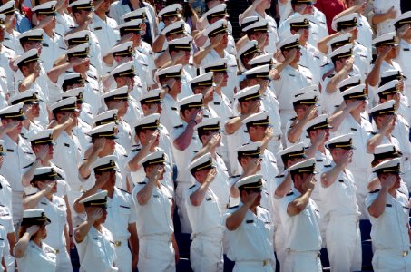 US Navy 050527-N-9693M-008 U.S. Naval Academy Midshipmen salute during the National Anthem as part of the opening ceremonies for the class of 2005 Graduation and Commissioning Ceremony