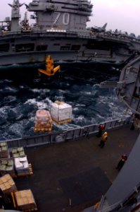 US Navy 050429-N-9273C-022 Sailors assigned to Deck Department aboard the fast combat support ship USS Camden (AOE 2) send a fuel probe across to the Nimitz-class aircraft carrier USS Carl Vinson (CVN 70)
