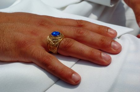 US Navy 050527-N-9693M-026 A newly commissioned Ensign displays a U.S. Naval Academy ring in the moments prior to the