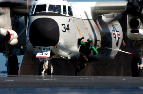 US Navy 050518-N-0226M-177 Topside Safety Petty Officer, Aviation Boatswain's Mate Jeffery Fournier, clears the launch area as he signals to the Catapult Officer that a C-2A Greyhound is ready to be launched