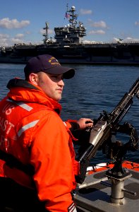 US Navy 050519-G-0000H-001 Coast Guard Petty Officer 3rd Class Sean Campbell, from Winthrop, Mass., mans a M-240 machine gun aboard a rigid hull inflatable boat