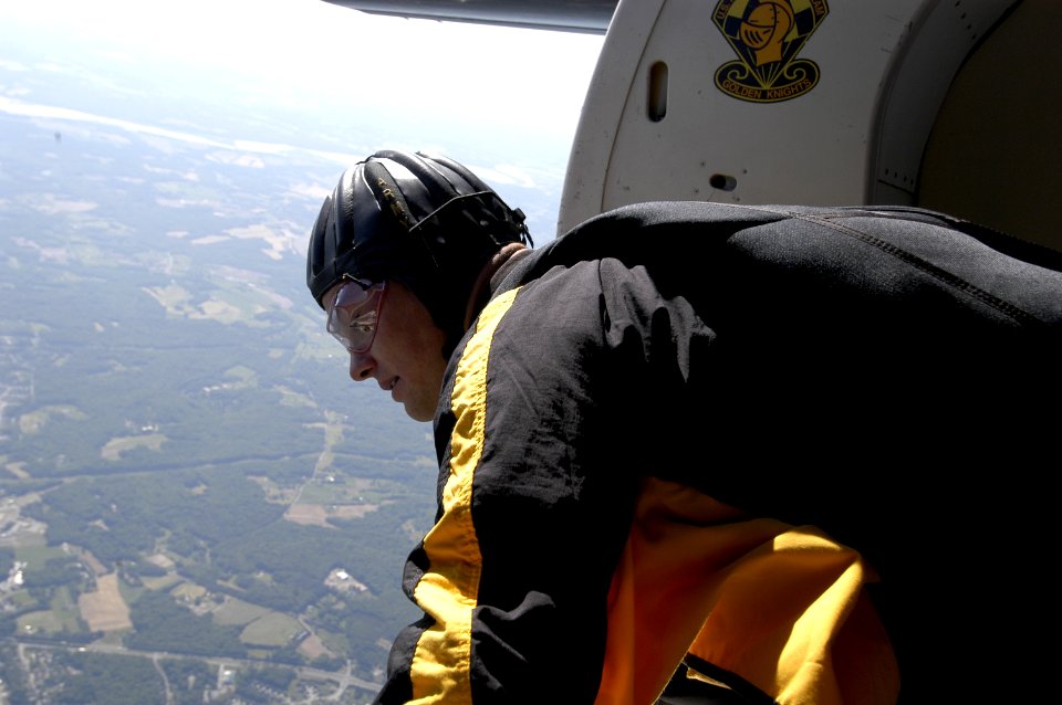 US Navy 050521-N-0295M-008 A member of the U.S. Army Parachute Team, the Golden Knights, prepares to jump from their C-31 jump plane at 12,500 feet above Andrews Air Force Base during the 2005 Joint Service Open House