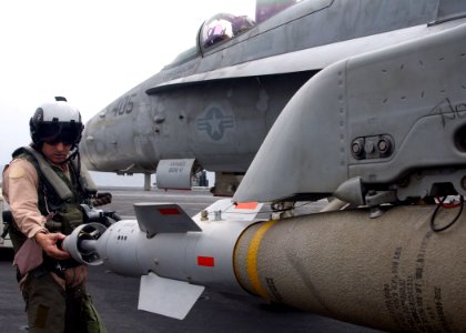 US Navy 050520-N-7265L-008 Carrier Air Wing Nine (CVW-9) Commanding Officer, Capt. James Spence, inspects a Laser Guided Bomb during pre-flight checks of an F-A-18C Hornet