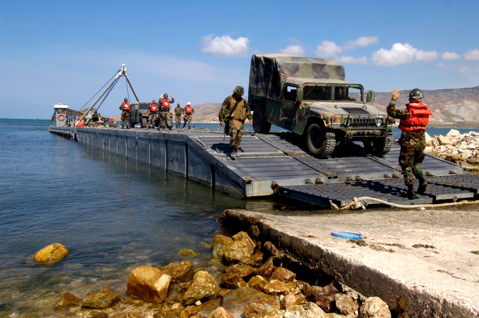 US Navy 050509-N-3642E-012 Sailors assigned to the amphibious transport dock ship USS Austin (LPD 4) load a tactical vehicle from the U.S. Virgin Islands National Guard's 640th Water Purification Unit