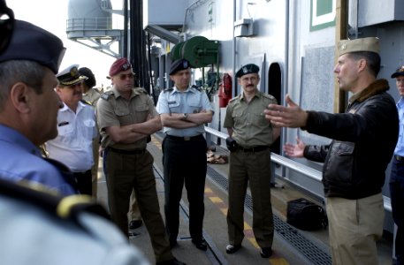US Navy 050531-N-9866B-023 Air Boss of the amphibious assault ship USS Peleliu (LHA 5), Cmdr. James Cox, speaks to a group of Polish flag officers visiting as a delegation from the National Defense University