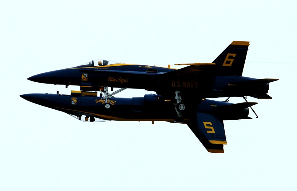 US Navy 050416-N-0295M-179 The Lead and Opposing Solo F-A-18A Hornets, assigned to the U.S. Navy flight demonstration team, the Blue Angels, perform the mirror pass in front of the crowd at the 2005 Coastal Carolina Air Show in