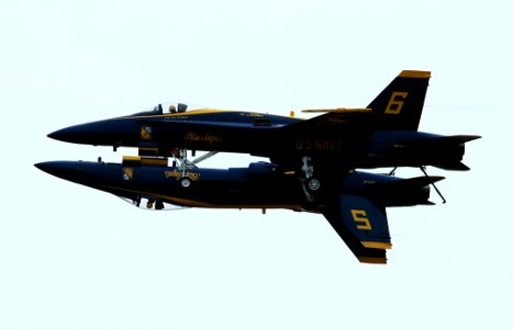 US Navy 050416-N-0295M-179 The Lead and Opposing Solo F-A-18A Hornets, assigned to the U.S. Navy flight demonstration team, the Blue Angels, perform the mirror pass in front of the crowd at the 2005 Coastal Carolina Air Show in