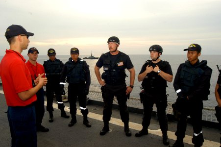 US Navy 050606-N-4104L-020 Members of the combined USS Rodney M. Davis (FFG 60) and RSS Independence visit, board, search and seizure (VBSS) team are debriefed