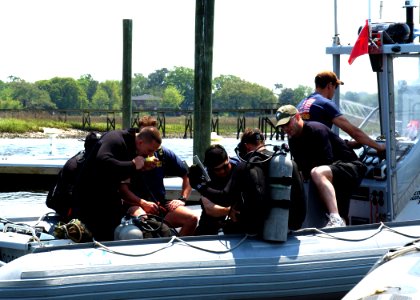 US Navy 050421-D-5613J-003 An Explosive Ordnance Disposal Mobile Unit Six (EODMU-6) team performs an equipment check as they depart the dock for a search of a crashed U.S. Air Force F-16 Falcon