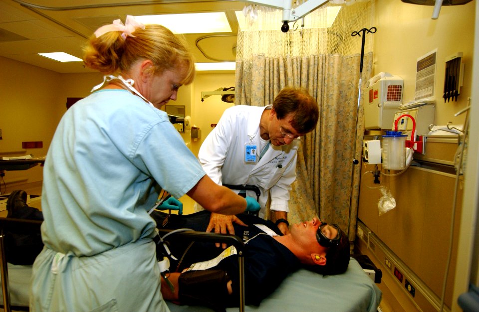 US Navy 050526-F-5586B-077 Shannon Bathurst, left, Emergency Medical Technician and John Hybart, Medical Director Emergency Department performs a medical evaluation to a simulated patient during exercise Lifesaver 2005