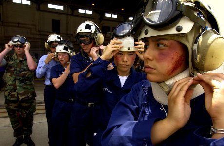 US Navy 050526-F-6655M-164 Navy A School students assigned to Naval Air Station Pensacola, Fla., don safety helmets and goggles before loading into a CH-3 transport helicopter during exercise Lifesaver 2005