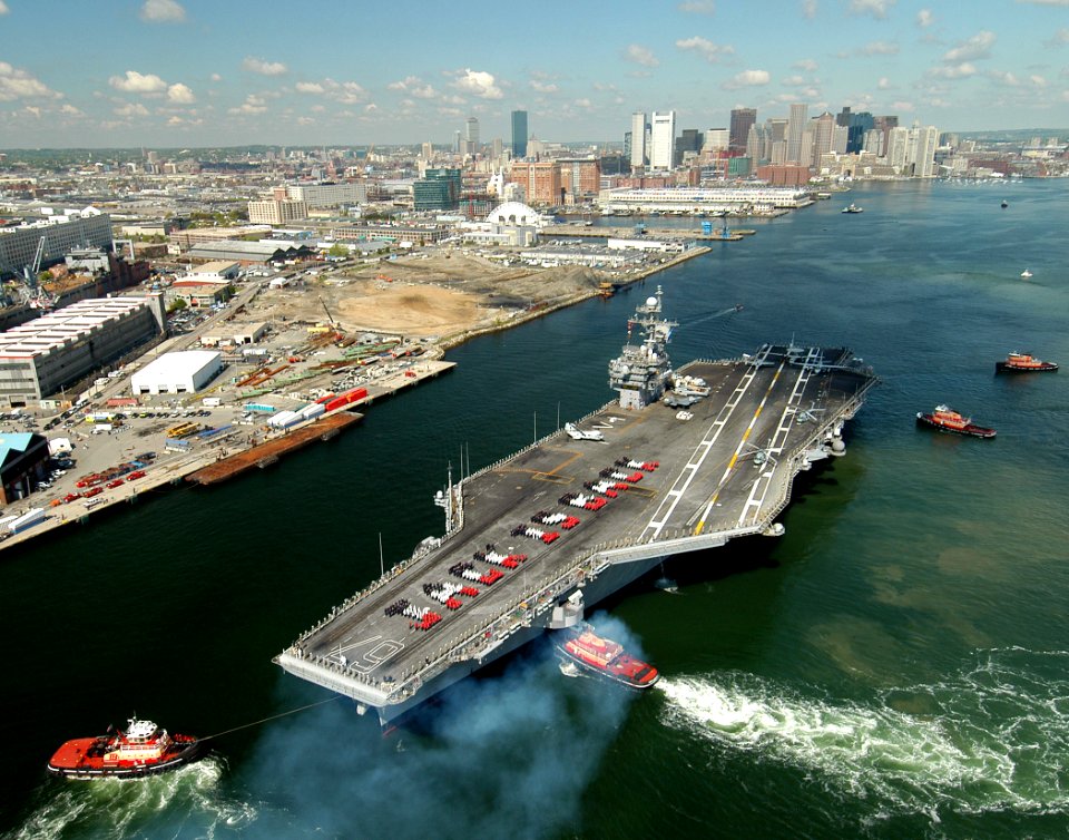 US Navy 050519-N-8704K-001 The conventionally powered aircraft carrier USS John F. Kennedy (CV 67) makes her way into historic Boston Harbor as crew members are in formation on the flight deck to spell-out JACK IS BACK