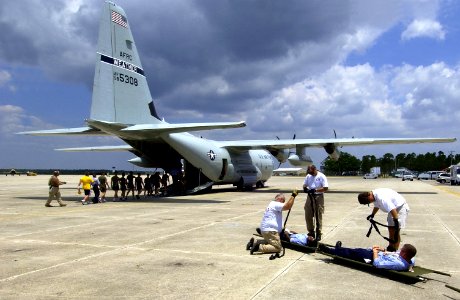 US Navy 050526-F-6655M-223 Navy A School students assigned to Naval Air Station Pensacola, Fla., onload a WC-130J Hurricane Hunter from the 53rd Weather Reconnaissance Squadron, Keeseler Air Force Base, Miss