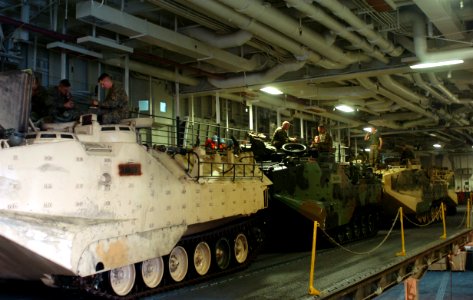 US Navy 050615-N-9866B-005 Marines assigned to the 3rd Amphibious Assault Battalion, stationed at Camp Pendleton, Calif., relax on their amphibious assault vehicles after embarking aboard the amphibious assault ship USS Peleliu
