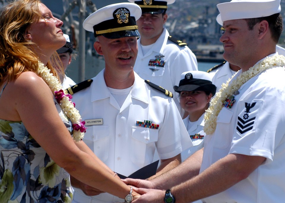 US Navy 050526-N-3019M-005 Engineman 1st Class Noah Lanham, assigned to the dock landing ship USS Rushmore (LSD 47), holds his wife's hands
