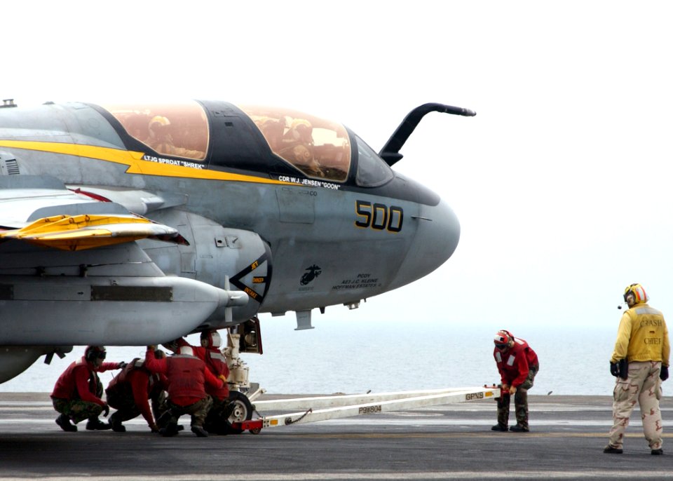 US Navy 050520-N-7265L-017 Crash and Salvage crew members attach a tow-bar to an EA-6B Prowler assigned to the Yellow Jackets of Electronic Attack Squadron One Three Eight (VAQ-138)