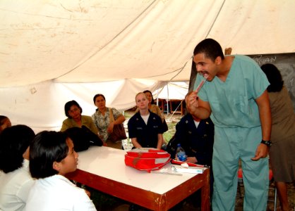 US Navy 050427-N-0357S-012 Dental Technician 3rd Class Ryan Hill teaches students the proper use of a toothbrush at a school on the island of Nias