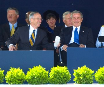 US Navy 050527-N-9693M-012 President George W. Bush and Secretary of the Navy Gordon England share a humorous moment during the U.S. Naval Academy class of 2005 Graduation and Commissioning Ceremony