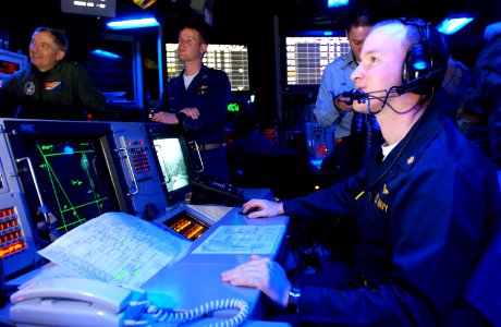 US Navy 050616-N-0000P-073 Commander, Carrier Strike Group Five (CSG-5), Rear Adm. Jamie D. Kelly, left, and personnel monitor computer screens in the Combat Direction Center aboard USS Kitty Hawk (CV 63)