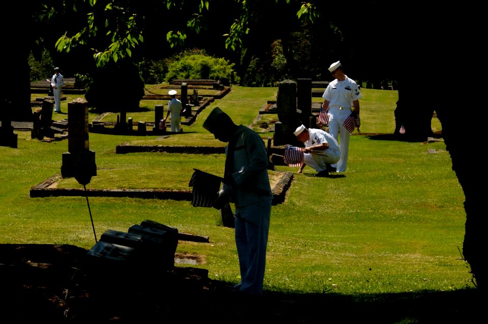 US Navy 050527-N-6477M-284 Sailors assigned to Naval Station Everett and the Nimitz-class aircraft carrier USS Abraham Lincoln (CVN 72) place American flags at the headstones of veterans