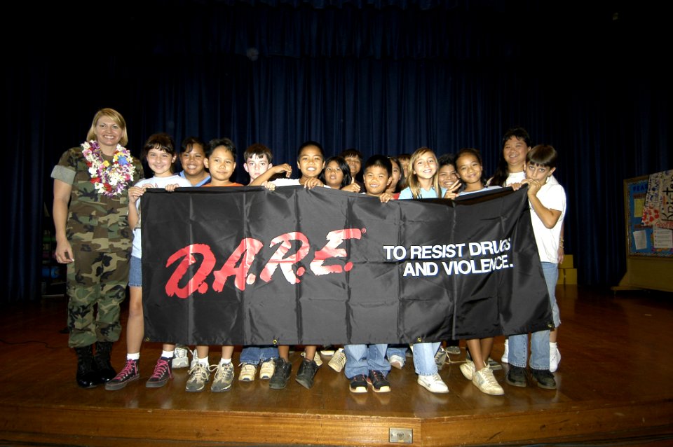 US Navy 050531-N-3207B-046 Master-at-Arms 1st Class Stacey Carfley stands with her recent class of Drug Abuse Resistance Education (D.A.R.E.) program graduates at Pearl Harbor Elementary School