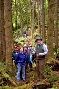 US Navy 050618-N-3390M-194 Walter Briggs, assigned to Naval Facilities Engineering Command, Poulsbo, Wash., right, leads a guided tour of the Jim Creek Old Growth Forest