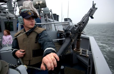 US Navy 050531-N-9851B-008 Gunner's Mate 3rd Class David Rizkallah stands force protection watch with an M-240 machine gun on the bridge wing of the guided missile destroyer USS John S. McCain