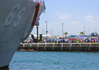 US Navy 050606-N-1356A-022 Families and friends wait patiently as the guided missile destroyer USS Milius (DDG 69) edges closer to the pier at Naval Station San Diego