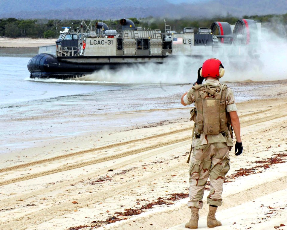 US Navy 050619-N-3455P-002 A beachmaster watches as a Landing Craft, Air Cushion (LCAC) vehicle take off after dropping off Australian Army Soldiers at Sabina Point during exercise Talisman Saber 2005