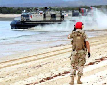 US Navy 050619-N-3455P-002 A beachmaster watches as a Landing Craft, Air Cushion (LCAC) vehicle take off after dropping off Australian Army Soldiers at Sabina Point during exercise Talisman Saber 2005
