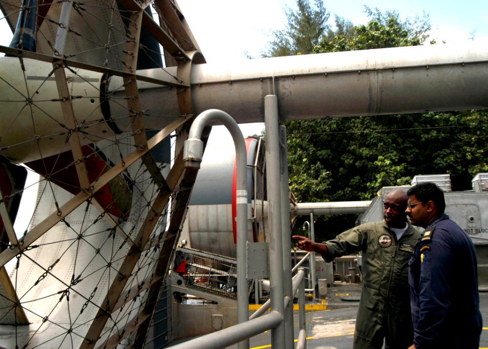US Navy 050603-N-4104L-002 Chief Gas Turbine System Technician Mechanical Francis Frederick, left, explains Landing Craft Air Cushion operations to Republic of Singapore Navy Cpt. Rajesh Dhillon