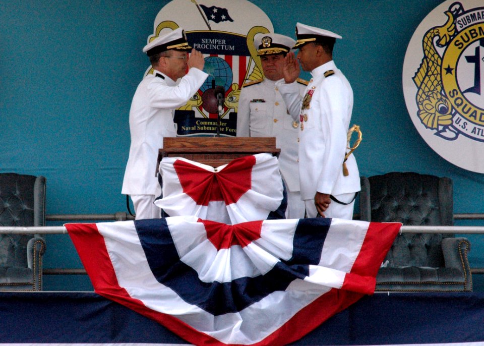 US Navy 050513-N-2820Z-002 Rear Adm. Mark W. Kenny watches as Capt. Robert M. Hennegan, left, relieves Capt. Bruce W. Grooms, right, as commander Submarine Squadron Six